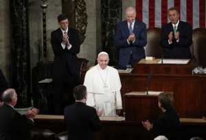 Vice President Joe Biden and House Speaker John Boehner of Ohio and others applaud Pope Francis as he arrives to address a joint meeting of Congress on Capitol Hill in Washington, Thursday, Sept. 24, 2015, making history as the first pontiff to do so. (AP Photo/Carolyn Kaster)