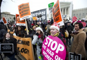 Anti-abortion Alicia Arbisi, front right, and her group, stand face-to-face against abortion rights demonstrators as abortion opponents march in front of the U.S. Supreme Court in Washington, Friday, Jan. 25, 2013, in a demonstration that coincides with the landmark U.S. Supreme Court decision that created a constitutional, nationwide right to abortion. (AP Photo/Manuel Balce Ceneta)